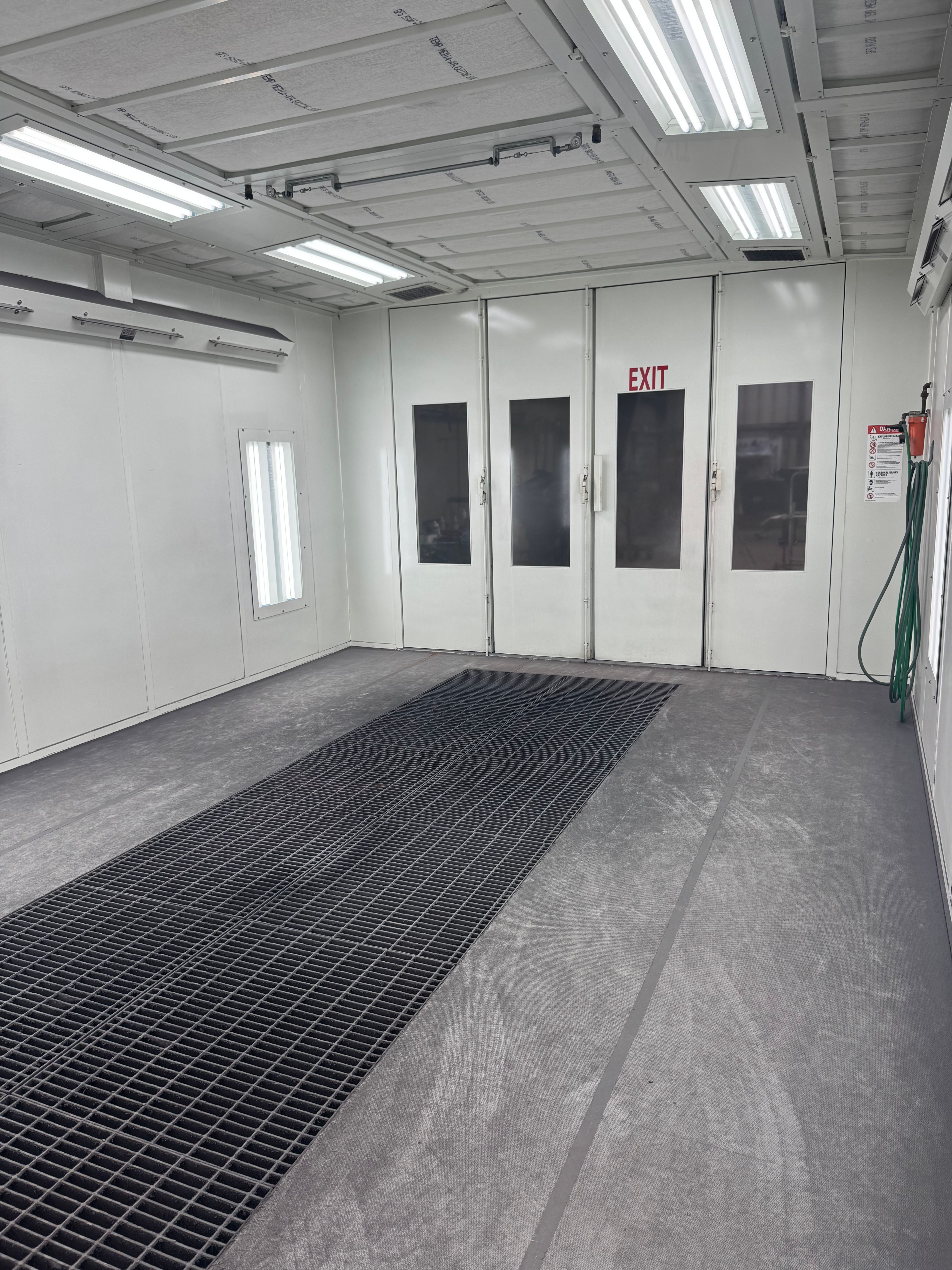 Interior of the paint booth showing the exit doors and floor grating
